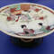 The pearls don't detract from the beautifully painted plate. It's 3.5 inches high by 7 inches wide.